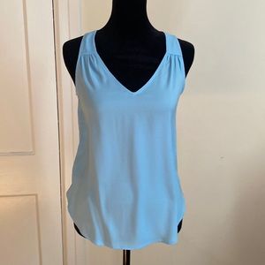 Light blue spring blouse. Blouse is sleeveless w detail around front straps.